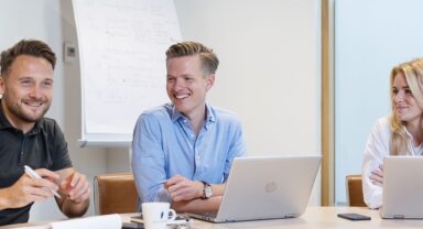 colleagues in a meeting smiling