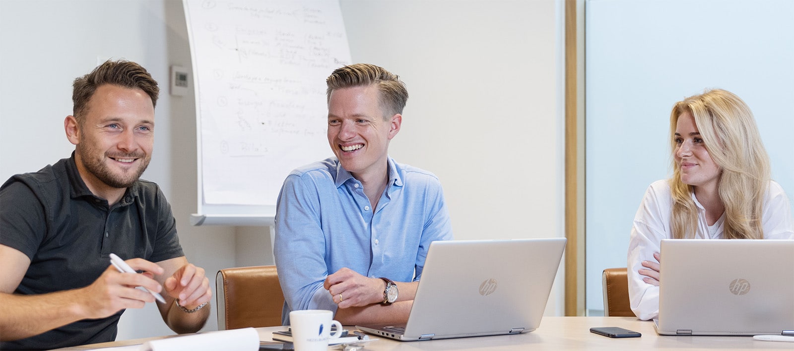 colleagues in a meeting smiling